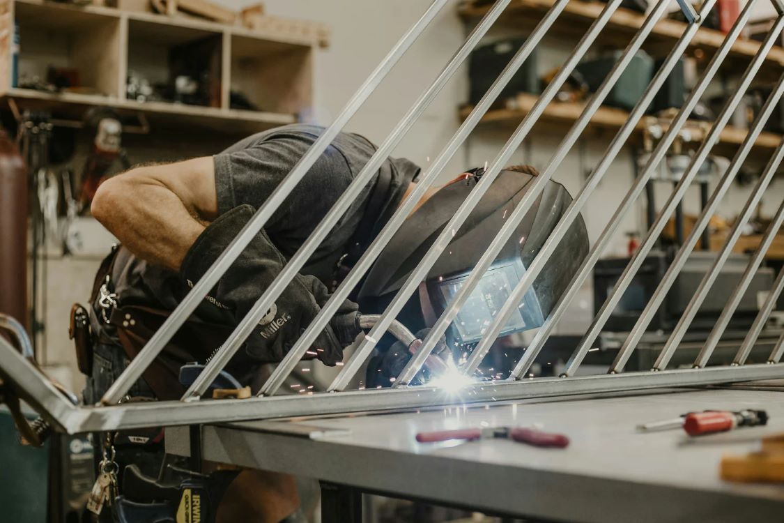 MAN WELDING SPINDLES IN TO A PANEL