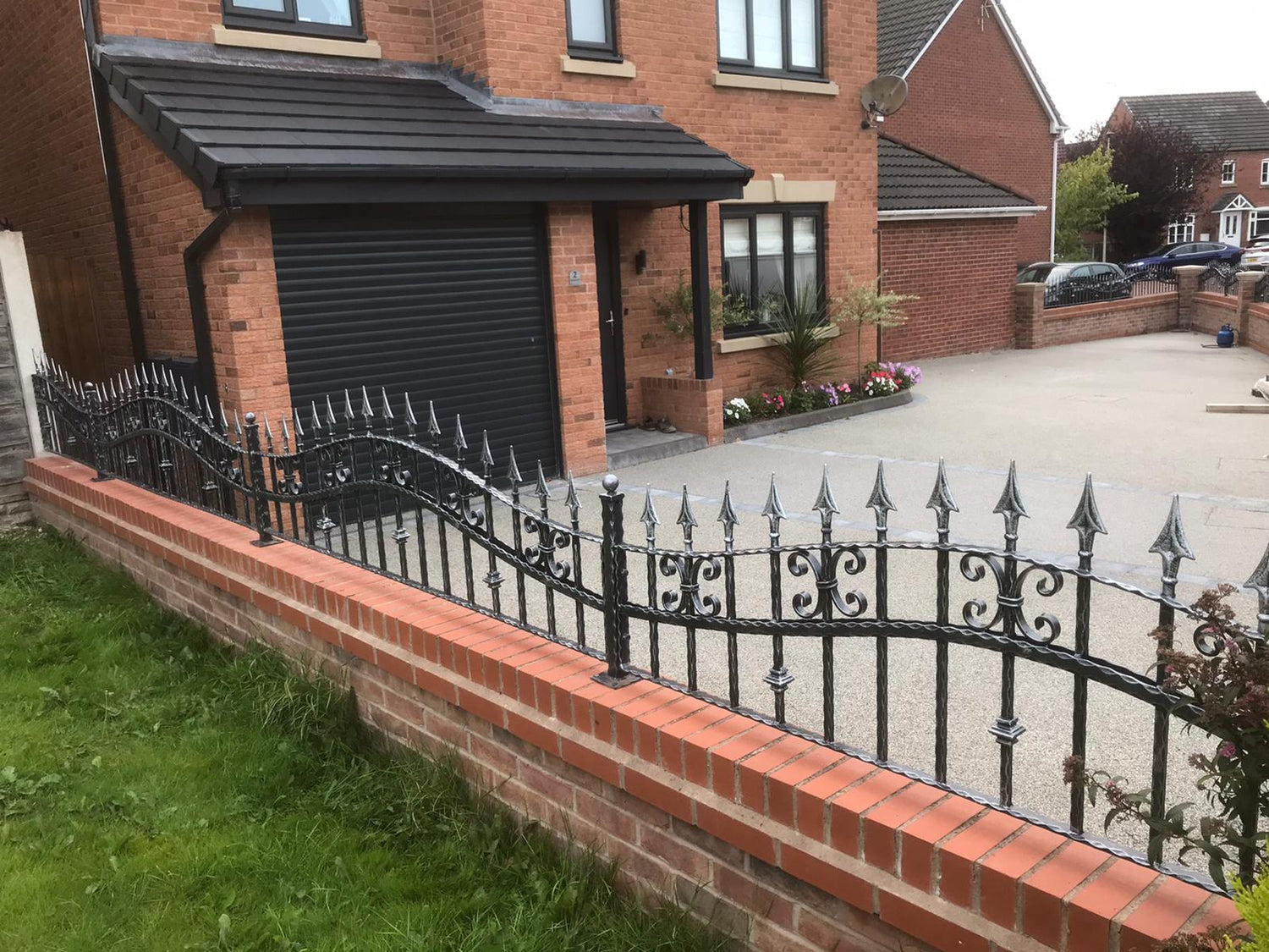 custom made wrought iron railings fitted on top of wall